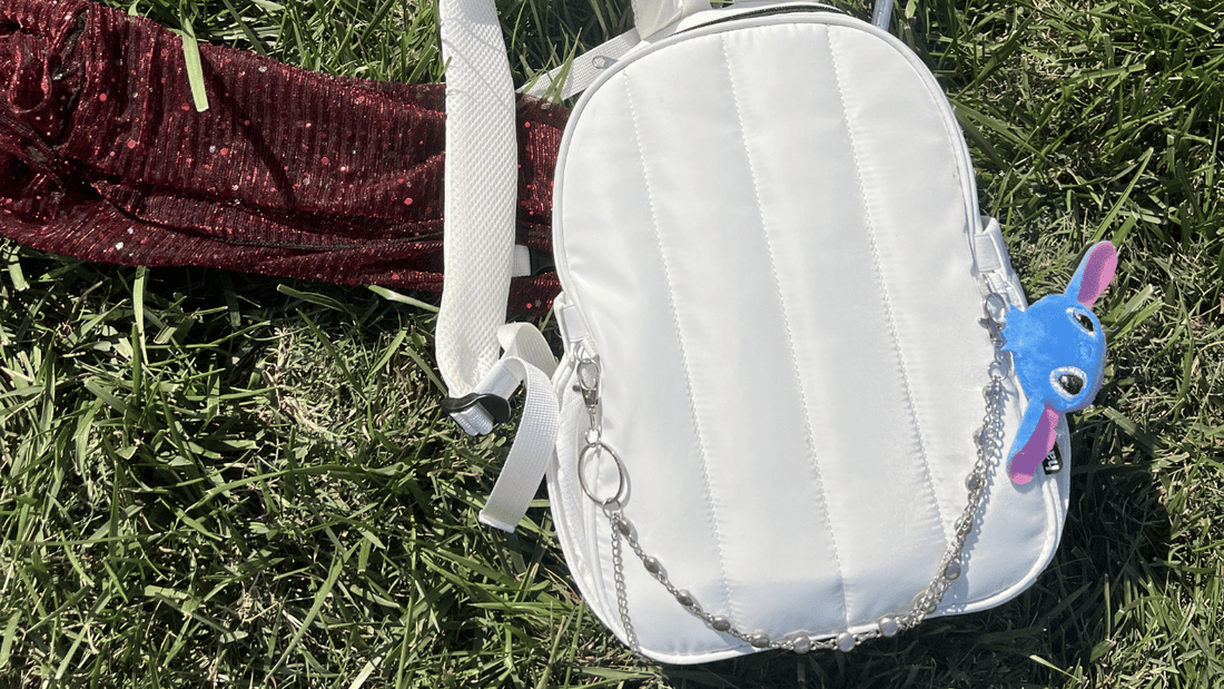 Hauter Water Bag festival hydration backpack on grass with festival essentials