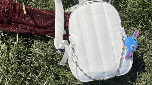 Hauter Water Bag festival hydration backpack on grass with festival essentials
