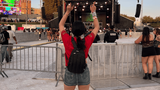 Woman with hauter festival hydration backpack at outdoor festival