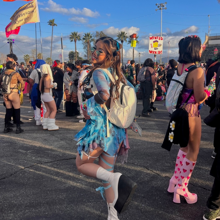woman at music festival with hydration backpack
