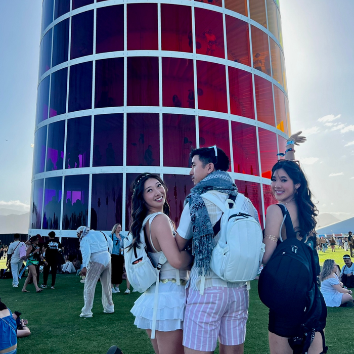 a man and two woman at music festival