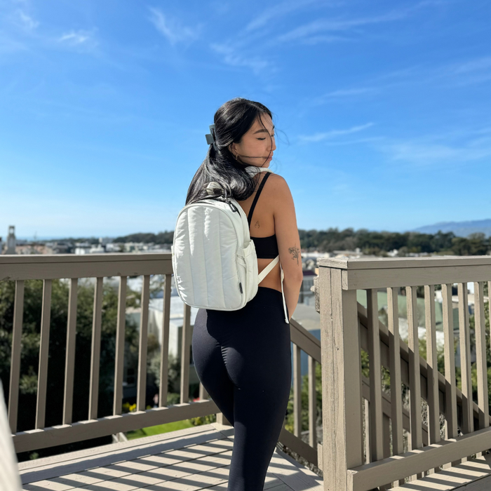 a woman outside with a hydration backpack